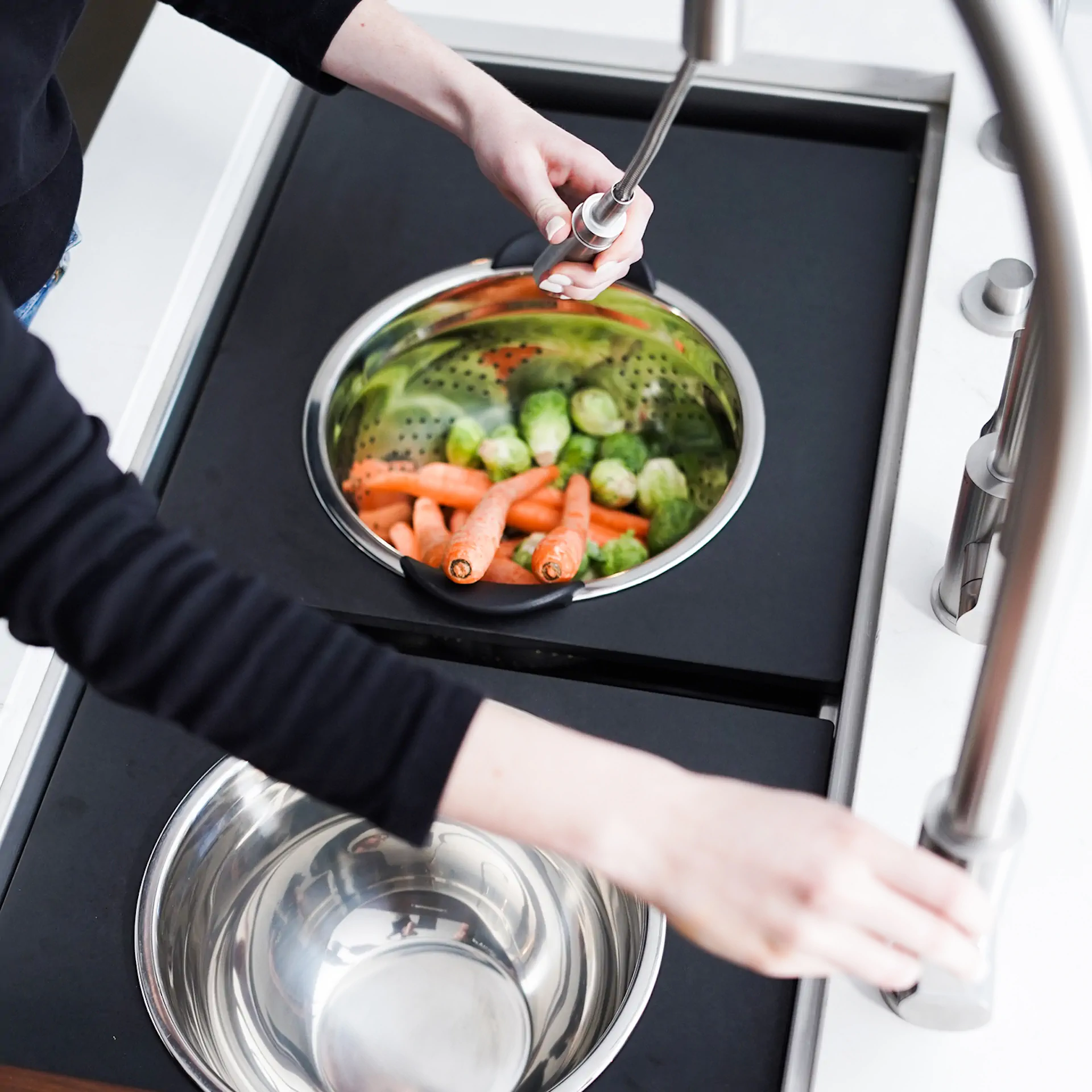The Galley Tap with hand spray used over a workstation sink